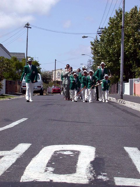 Die Young Guiding Stars Cacred String Band Est 1932 marschiert zu ihrer siebzigsten Geburtstagsfeier an in Landsdowne (Cape Town) ein
